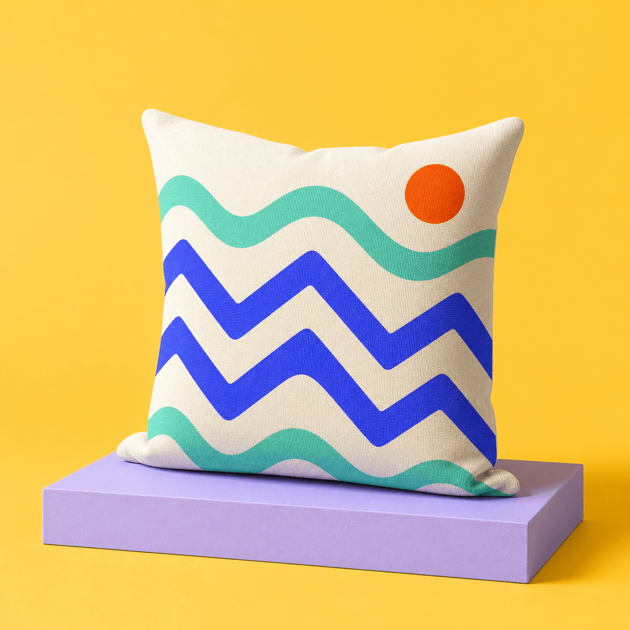 Pillow printed with mint waves and cobalt zigzags